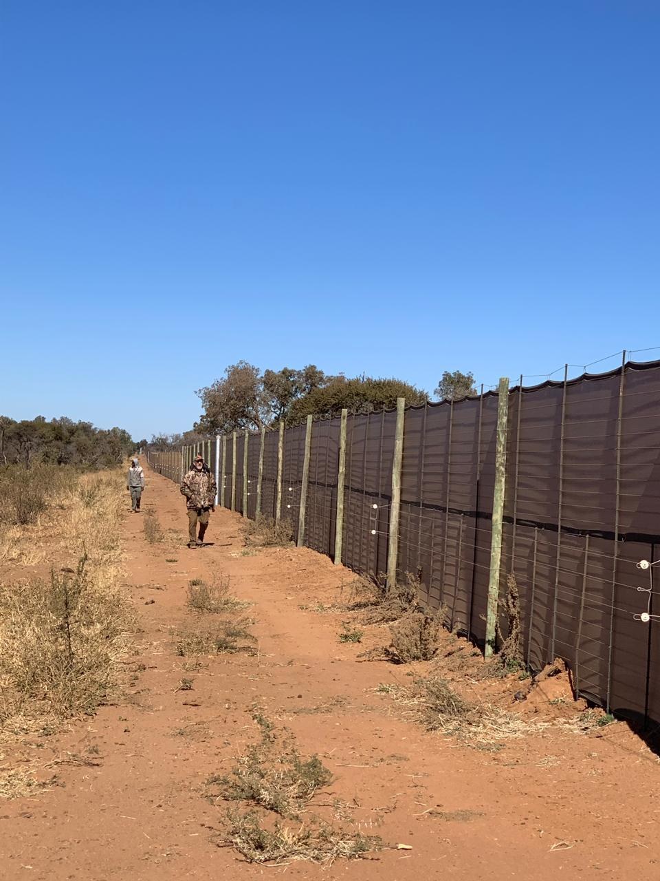 Game capture sail installed along a fence line in the field